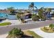Aerial view of home with paved driveway and tropical landscaping at 545 Lillian Dr, Madeira Beach, FL 33708