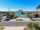 Aerial view of a waterfront home with a paved driveway at 545 Lillian Dr, Madeira Beach, FL 33708