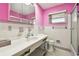 Pink bathroom with white tiled walls, a vanity, and a shower at 545 Lillian Dr, Madeira Beach, FL 33708