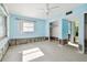 A bedroom in need of repair, showcasing light blue walls and a ceiling fan at 545 Lillian Dr, Madeira Beach, FL 33708