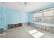 A light blue bedroom requiring renovation, showing water damage and exposed walls at 545 Lillian Dr, Madeira Beach, FL 33708