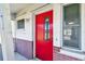 Red front door with floral glass accents at 545 Lillian Dr, Madeira Beach, FL 33708