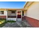 Enclosed entryway with a red door and brick walls at 545 Lillian Dr, Madeira Beach, FL 33708