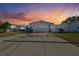House exterior with a white, single-story home and a two-car garage at 545 Lillian Dr, Madeira Beach, FL 33708