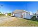 Side view of house with a detached garage and white fence at 545 Lillian Dr, Madeira Beach, FL 33708