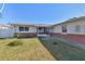 House exterior with a screened-in porch and a brick facade at 545 Lillian Dr, Madeira Beach, FL 33708