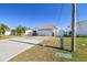 House exterior showcasing a spacious driveway and well-maintained lawn at 545 Lillian Dr, Madeira Beach, FL 33708
