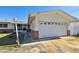 Front view of house showcasing a garage and a brick facade at 545 Lillian Dr, Madeira Beach, FL 33708