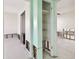 A light green hallway with water damage and access to other rooms at 545 Lillian Dr, Madeira Beach, FL 33708