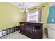 A kitchen with dark wood island and yellow walls, ready for a remodel at 545 Lillian Dr, Madeira Beach, FL 33708