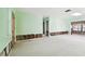 Renovation project: spacious living room with light green walls and wood flooring at 545 Lillian Dr, Madeira Beach, FL 33708