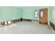 Renovation in progress: light green walls and wood flooring in a living room at 545 Lillian Dr, Madeira Beach, FL 33708