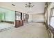 Spacious living area with water damage and built-in shelving at 545 Lillian Dr, Madeira Beach, FL 33708