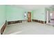 A living room undergoing renovation, featuring light green walls and new flooring at 545 Lillian Dr, Madeira Beach, FL 33708