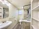 Updated bathroom with a toilet, sink, shower, and built-in shelving at 5626 28Th S Ave, Gulfport, FL 33707