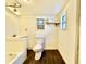 Small bathroom with a toilet, shower/tub combo, and dark tile floor at 5626 28Th S Ave, Gulfport, FL 33707