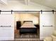 Bedroom with barn doors and a queen-sized bed at 5626 28Th S Ave, Gulfport, FL 33707