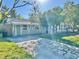 Attractive light green house with a long driveway and manicured lawn at 5626 28Th S Ave, Gulfport, FL 33707