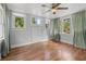 Bright bedroom featuring hardwood floors and multiple windows at 5710 N Miami Ave, Tampa, FL 33604