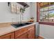 Modern kitchen sink with a stainless steel faucet and tan countertop at 5710 N Miami Ave, Tampa, FL 33604