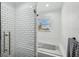 Clean bathroom with white subway tile shower and a soaking tub at 6604 Blue Heron S Dr, St Petersburg, FL 33707