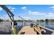 Wooden dock with boat lift overlooking calm water at 8800 Sunlit Cove Ne Dr, St Petersburg, FL 33702