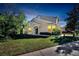 Two-story house exterior at dusk, well-lit, landscaped at 9776 Carlsdale Dr, Riverview, FL 33578