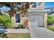 House exterior showcasing a white garage door and landscaping at 9776 Carlsdale Dr, Riverview, FL 33578