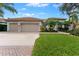 3-car garage, manicured lawn, and attractive curb appeal at 9901 Tree Tops Lake Rd, Tampa, FL 33626