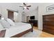 Spacious main bedroom with king-size bed, dark wood furniture, and barn door at 9901 Tree Tops Lake Rd, Tampa, FL 33626