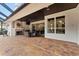 Covered patio with fireplace and view of the pool at 9901 Tree Tops Lake Rd, Tampa, FL 33626