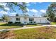 White single story home with attached two-car garage, nicely landscaped lawn at 4666 Helena Ne St, St Petersburg, FL 33703