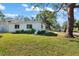 View of the home's side, showcasing its landscaping and street view at 4666 Helena Ne St, St Petersburg, FL 33703