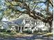 Two-story light gray building with black shutters and landscaping at 11775 Raintree Dr, Tampa, FL 33617