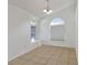 Simple dining area with neutral tile floors and two arched windows at 1231 Barmere Ln, Brandon, FL 33511