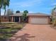Charming single-story home featuring a brick driveway, lush landscaping, and a well-maintained two-car garage at 1285 79Th St S, St Petersburg, FL 33707