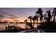 Relaxing poolside view at sunset with palm trees, dock, and water view at 1285 79Th St S, St Petersburg, FL 33707