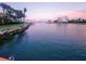 Picturesque waterfront view featuring palm trees, and calm water at sunset at 1285 79Th St S, St Petersburg, FL 33707