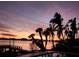 Stunning waterfront panorama showcasing the pool, skyline silhouette, and colorful sunset reflecting off the water at 1285 79Th St S, St Petersburg, FL 33707