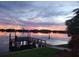 Sunset view of serene waterfront with dock reflecting vibrant colors, surrounded by lush greenery and tranquil ambiance at 1285 79Th St S, St Petersburg, FL 33707