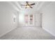 Main bedroom with carpet flooring and double doors to balcony at 1509 Riverside Dr, Tarpon Springs, FL 34689