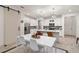 Bright dining area with white table and chairs, open to kitchen at 17827 Althea Blue Pl, Lutz, FL 33558