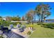 Spacious backyard with fire pit, patio, and lake view at 2624 Lake Manor Dr, Land O Lakes, FL 34639