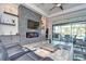 Living room with stone fireplace and sliding doors to patio at 2624 Lake Manor Dr, Land O Lakes, FL 34639