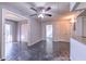 Living room with sliding doors to patio, metallic floors and ceiling fan at 2868 Somerset Park Dr # 103, Tampa, FL 33613