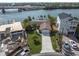 Aerial view of waterfront home with neighboring houses and under-construction property at 3606 Belle Vista E Dr, St Pete Beach, FL 33706