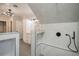 Modern bathroom featuring a luxurious marble shower with sleek fixtures and a chandelier at 37439 Meridian Ave, Dade City, FL 33525