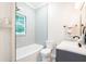 Bright bathroom featuring a tub with white subway tile and decorative tile flooring at 37439 Meridian Ave, Dade City, FL 33525