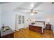 Cozy bedroom featuring hardwood floors, a ceiling fan, and ample natural light at 37439 Meridian Ave, Dade City, FL 33525