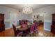 Elegant dining room featuring hardwood floors, chandelier, and festive fall decor at 37439 Meridian Ave, Dade City, FL 33525